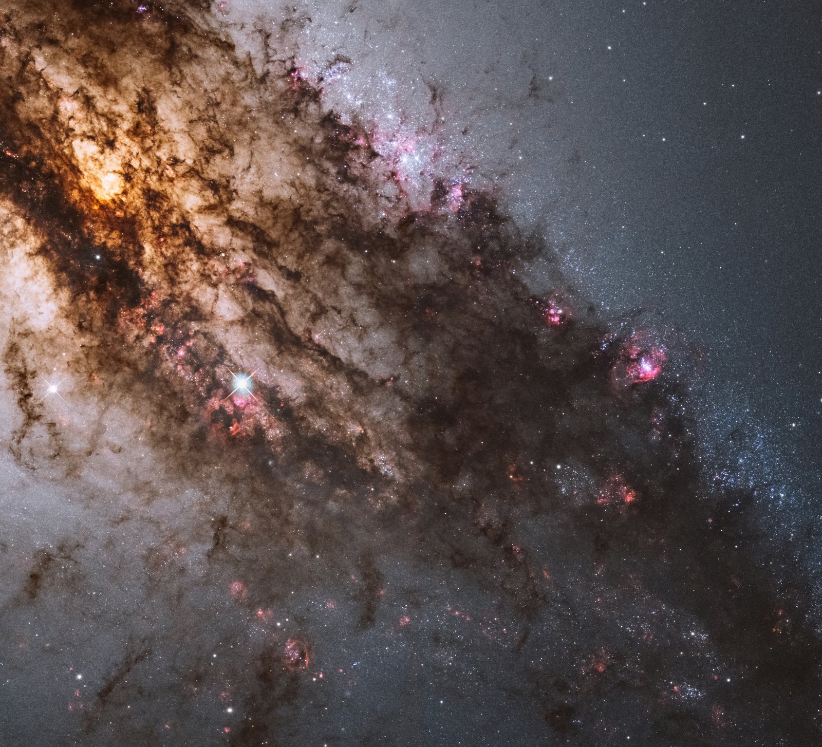 Centaurus A: The Galaxy That Hosts a Monster Black Hole and a Star Factory